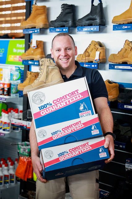 Jeremy holding some boxes of Steel Blue boots